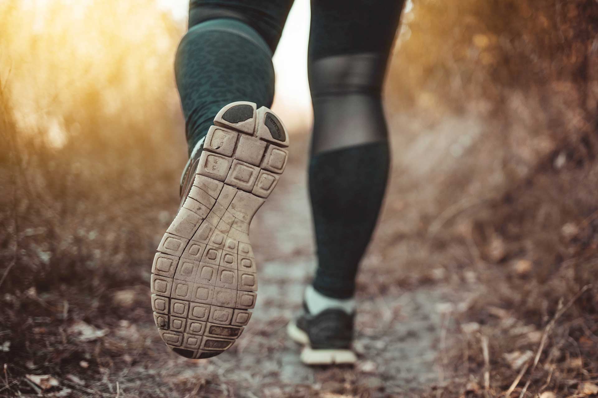 Run in the autumn forest - leg and foot view