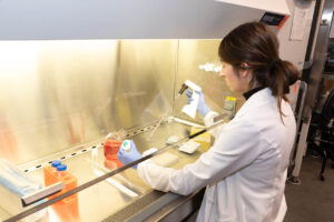 Axolotl Biologix employee works with a ventilation hood