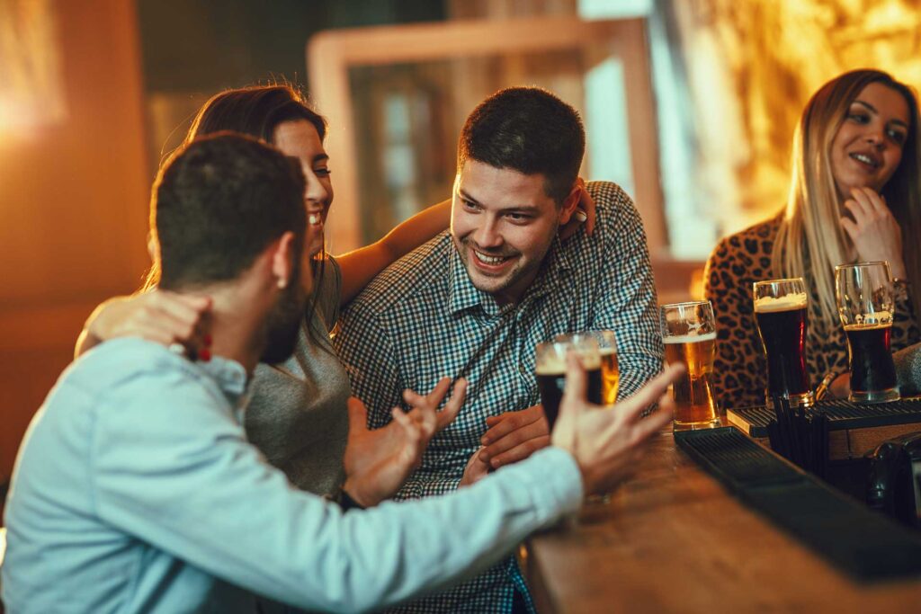 Friends celebrating a business success over beers.