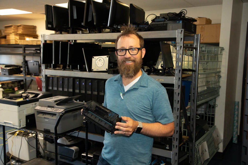 QC employee holds a toner cartridge.