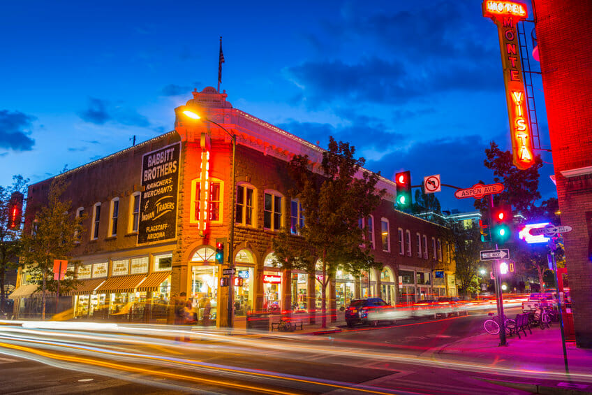 Flagstaff, Arizona at night with car lights passing Babbitt's Backcountry Outfitters