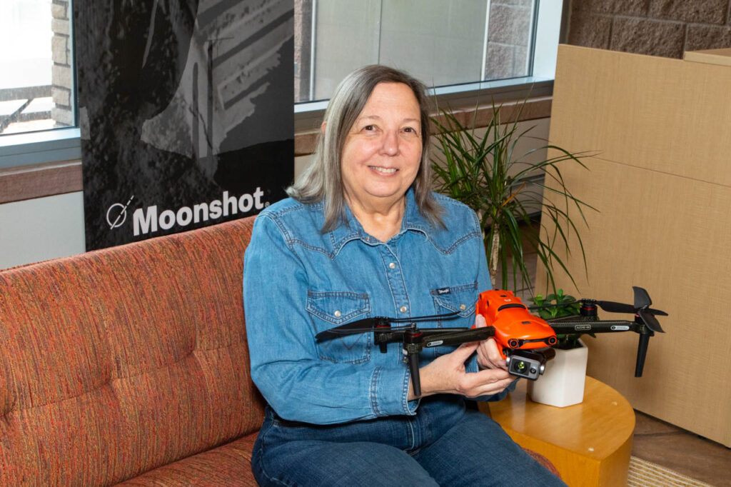 Ariel Strong at Moonshot holding a drone. 