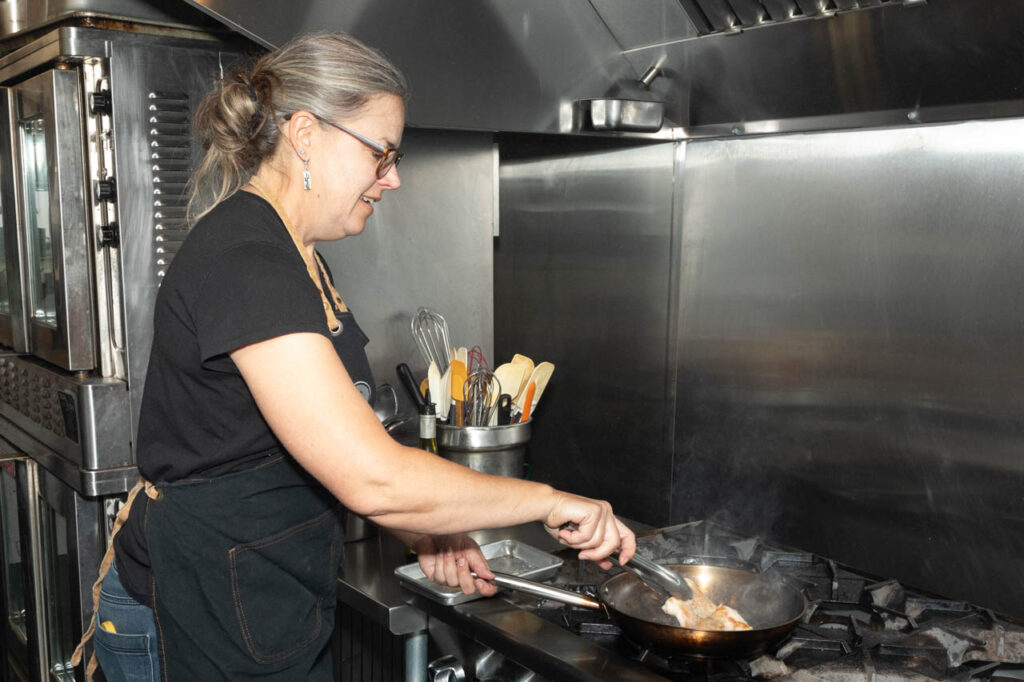 Laura Chamberlin cooks in prep kitchen.